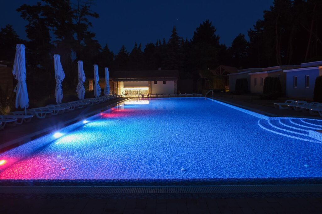 a stunning luxury pool shown at night