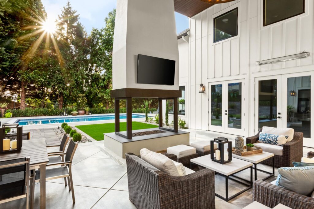 a luxury pool with an outdoor lounging area